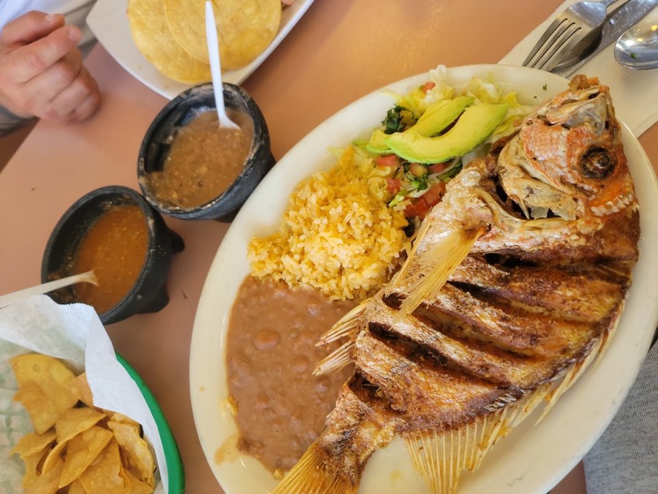 Colorful plates of Mexican food on a table.